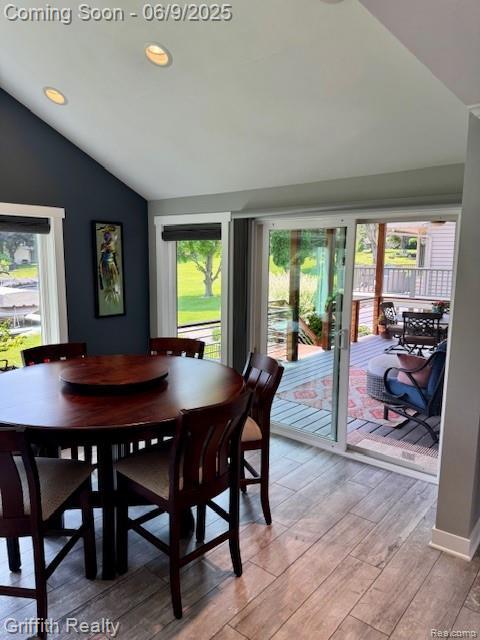 1158 Camelot Dr, Pinckney, MI 48169 - dining area with lofted ceiling, healthy amount of natural light, light wood-style floors, and recessed lighting