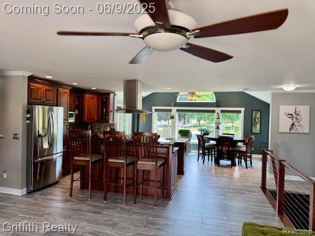 1158 Camelot Dr, Pinckney, MI 48169 - dining room with wood finished floors, baseboards, a ceiling fan, crown molding, and recessed lighting