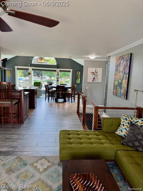1158 Camelot Dr, Pinckney, MI 48169 - living room featuring a ceiling fan, wood finished floors, plenty of natural light, and crown molding