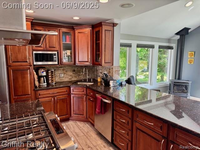 1158 Camelot Dr, Pinckney, MI 48169 - kitchen featuring stainless steel appliances, a sink, backsplash, dark stone counters, and recessed lighting