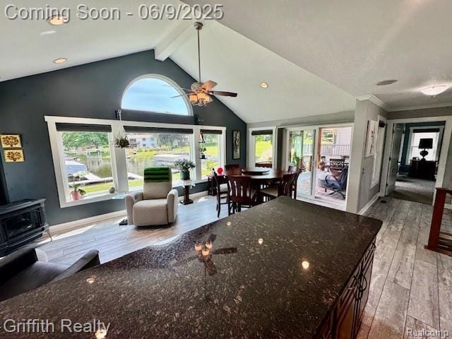 1158 Camelot Dr, Pinckney, MI 48169 - living area with a wood stove, hardwood / wood-style floors, ceiling fan, and baseboards