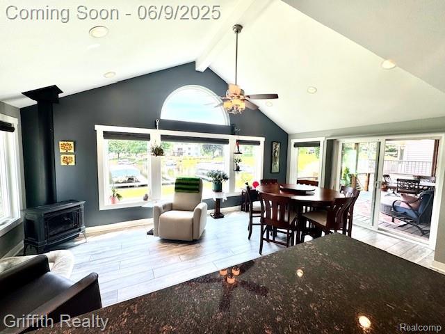 1158 Camelot Dr, Pinckney, MI 48169 - dining area with a wood stove, plenty of natural light, and wood finished floors
