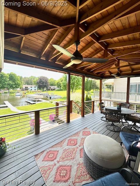 1158 Camelot Dr, Pinckney, MI 48169 - wooden deck with a water view, ceiling fan, and outdoor dining area