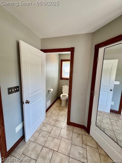 1158 Camelot Dr, Pinckney, MI 48169 - bathroom featuring toilet, baseboards, and tile patterned flooring