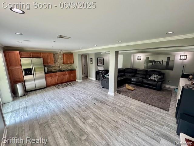 1158 Camelot Dr, Pinckney, MI 48169 - living room featuring ornamental molding, light wood-style flooring, recessed lighting, and baseboards