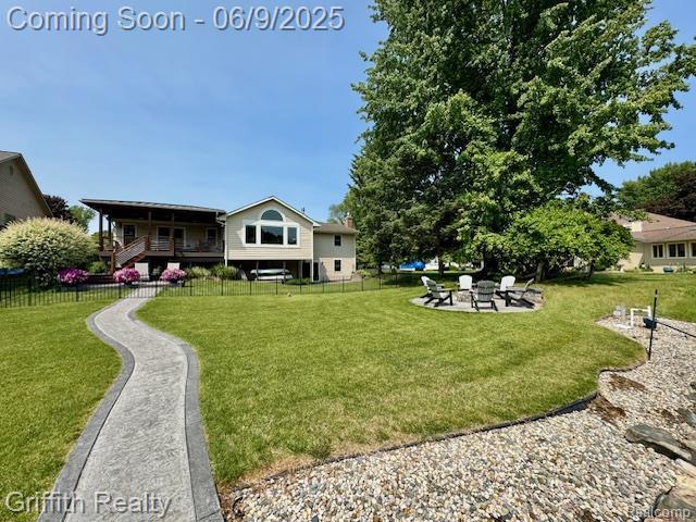 1158 Camelot Dr, Pinckney, MI 48169 - view of yard featuring a fire pit