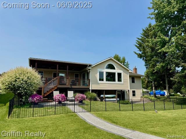 1158 Camelot Dr, Pinckney, MI 48169 - rear view of property featuring a chimney and stairway