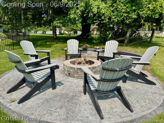 1158 Camelot Dr, Pinckney, MI 48169 - view of patio featuring an outdoor fire pit