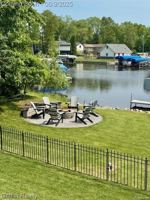 1158 Camelot Dr, Pinckney, MI 48169 - view of community with a fire pit, a water view, and a patio area