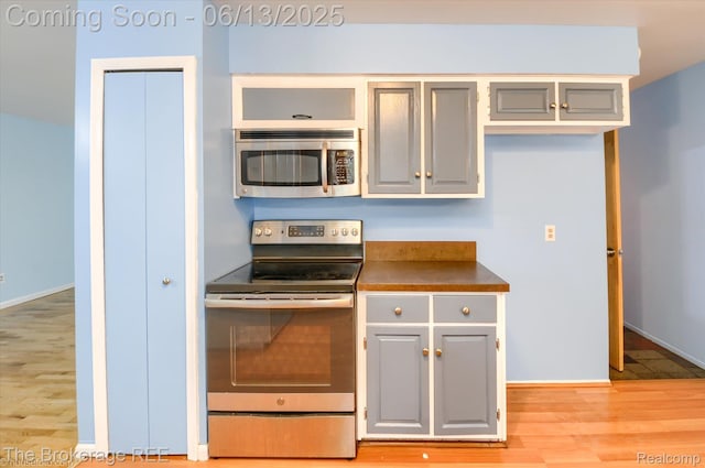 732 E Grand Blanc Rd, Grand Blanc, MI 48439 - kitchen with stainless steel appliances, gray cabinets, dark countertops, and light wood-style floors