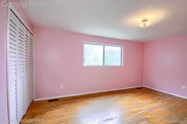 732 E Grand Blanc Rd, Grand Blanc, MI 48439 - unfurnished bedroom featuring hardwood / wood-style flooring, baseboards, and a closet