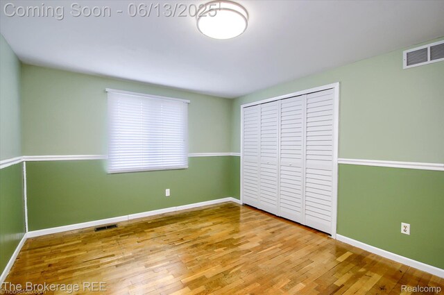 732 E Grand Blanc Rd, Grand Blanc, MI 48439 - unfurnished bedroom with wood finished floors, baseboards, and a closet