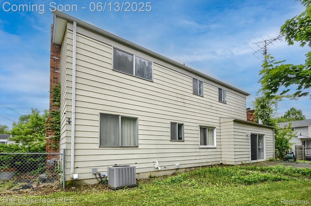 732 E Grand Blanc Rd, Grand Blanc, MI 48439 - rear view of house featuring cooling unit and a chimney