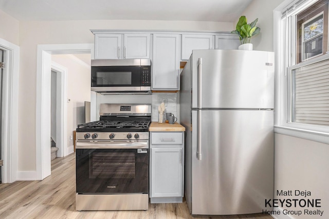 109 Leonard St NE, Grand Rapids, MI 49503 - kitchen with appliances with stainless steel finishes and light wood-style floors