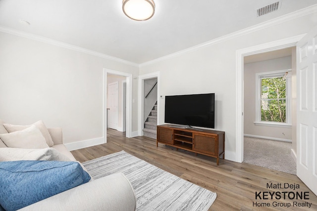 109 Leonard St NE, Grand Rapids, MI 49503 - living room featuring ornamental molding, baseboards, wood finished floors, and stairway