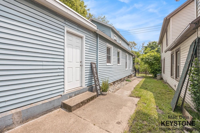 109 Leonard St NE, Grand Rapids, MI 49503 - view of exterior entry with a yard
