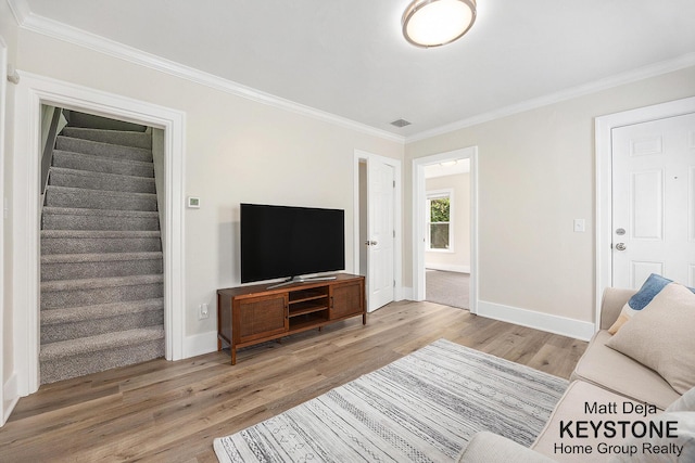 109 Leonard St NE, Grand Rapids, MI 49503 - living area with wood finished floors, ornamental molding, baseboards, and stairs