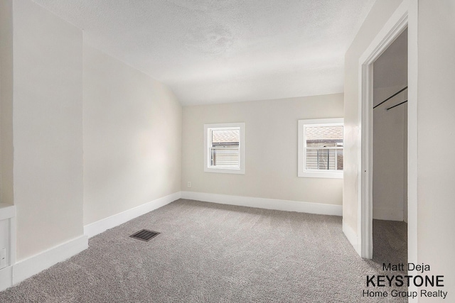109 Leonard St NE, Grand Rapids, MI 49503 - spare room featuring carpet floors, a textured ceiling, and baseboards