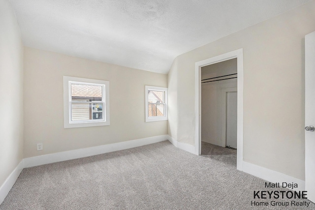 109 Leonard St NE, Grand Rapids, MI 49503 - unfurnished bedroom featuring carpet floors, multiple windows, and baseboards