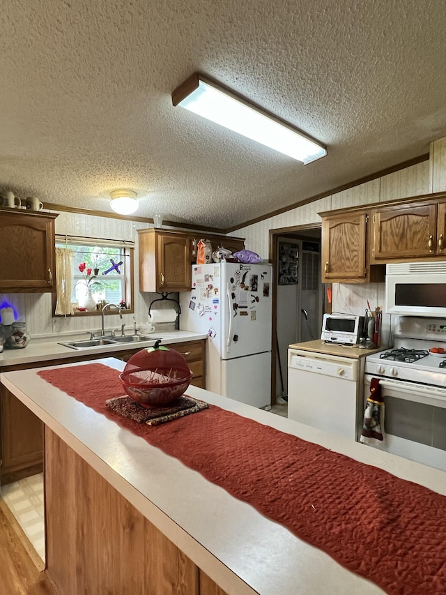 4153 Whisperwood Way S, Muskegon, MI 49442 - kitchen with white appliances, a sink, a textured ceiling, light countertops, and lofted ceiling