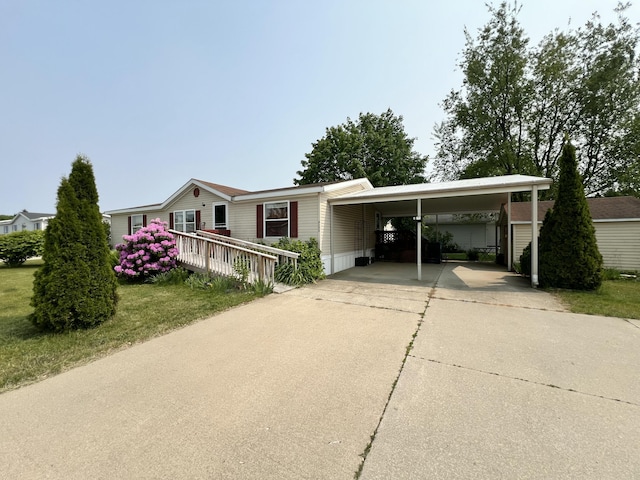4153 Whisperwood Way S, Muskegon, MI 49442 - manufactured / mobile home featuring driveway, an attached carport, and a front lawn