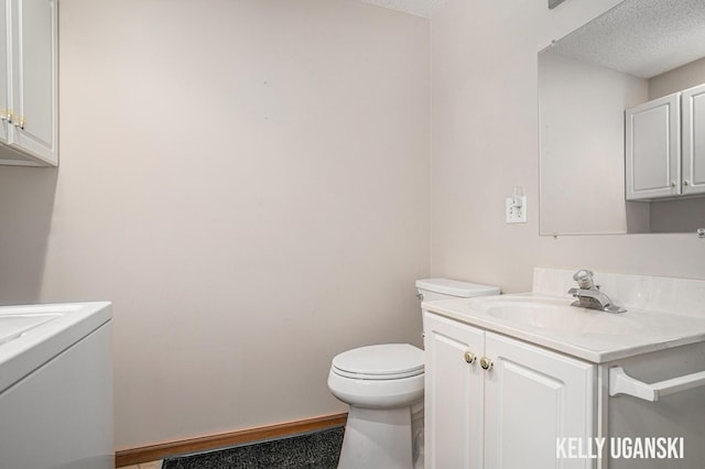 7460 Anthony St, Whitehall, MI 49461 - bathroom with vanity, a textured ceiling, toilet, and washer / clothes dryer