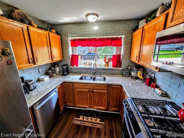 45009 Mitchell St, Grand Blanc, MI 48439 - kitchen with stainless steel appliances, a sink, dark wood-style floors, and tasteful backsplash