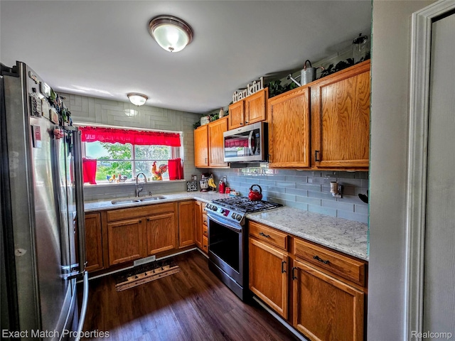 45009 Mitchell St, Grand Blanc, MI 48439 - kitchen featuring appliances with stainless steel finishes, a sink, dark wood-style floors, and brown cabinets
