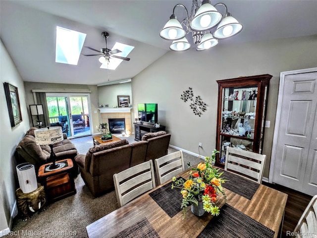 45009 Mitchell St, Grand Blanc, MI 48439 - living area featuring lofted ceiling, a skylight, baseboards, a tile fireplace, and a chandelier
