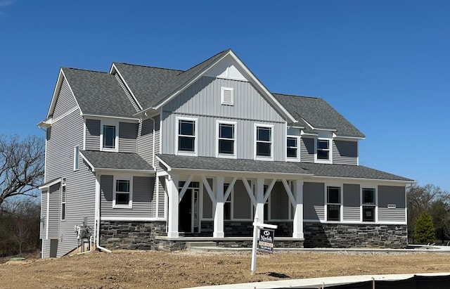 4846 W Burton Ln Unit 22, Saline, MI 48176 - view of front of house with covered porch, stone siding, and a shingled roof