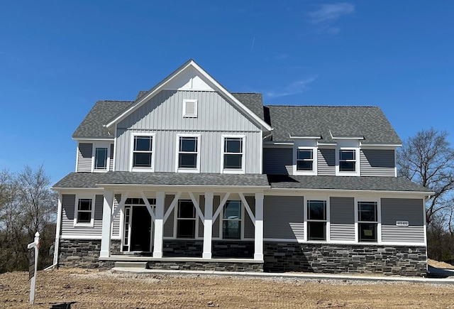 4846 W Burton Ln Unit 22, Saline, MI 48176 - view of front facade with a porch, stone siding, board and batten siding, and a shingled roof
