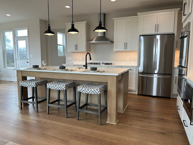 4846 W Burton Ln Unit 22, Saline, MI 48176 - kitchen with stainless steel appliances, recessed lighting, a kitchen island with sink, light countertops, and a kitchen breakfast bar
