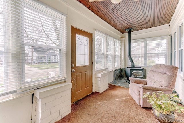 2210 Cambridge Rd, Berkley, MI 48072 - sunroom / solarium featuring a wood stove, carpet, and wood ceiling