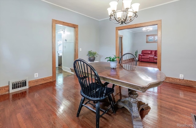 2210 Cambridge Rd, Berkley, MI 48072 - dining area with a chandelier, wood finished floors, crown molding, and baseboards