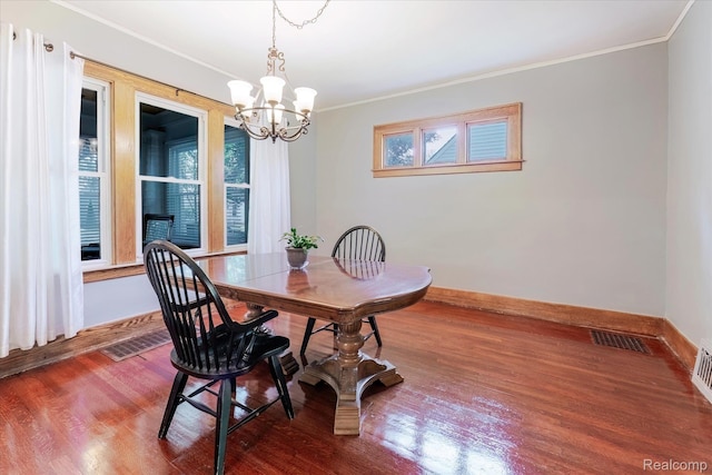 2210 Cambridge Rd, Berkley, MI 48072 - dining area with ornamental molding, wood finished floors, a chandelier, and baseboards