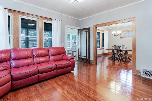 2210 Cambridge Rd, Berkley, MI 48072 - living room with a chandelier, wood finished floors, crown molding, and baseboards