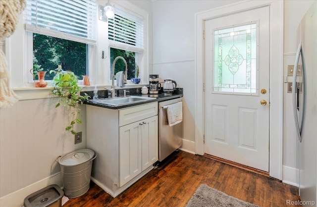 2210 Cambridge Rd, Berkley, MI 48072 - kitchen featuring appliances with stainless steel finishes, a sink, plenty of natural light, dark countertops, and a wainscoted wall