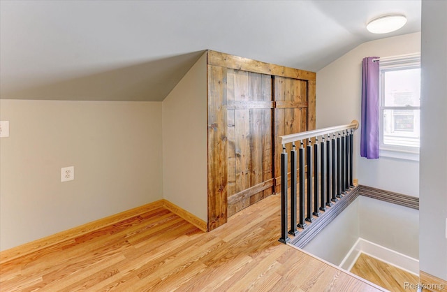 2210 Cambridge Rd, Berkley, MI 48072 - additional living space featuring vaulted ceiling, wood finished floors, and baseboards