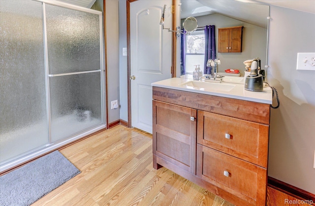 2210 Cambridge Rd, Berkley, MI 48072 - bathroom with wood finished floors, a stall shower, vanity, baseboards, and lofted ceiling