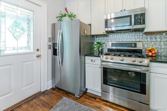 2210 Cambridge Rd, Berkley, MI 48072 - kitchen featuring appliances with stainless steel finishes, tasteful backsplash, dark wood-type flooring, and white cabinetry