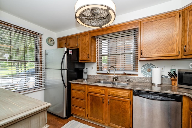 5576 N Watervliet Rd Unit 11, Watervliet, MI 49098 - kitchen featuring stainless steel appliances, a sink, wood finished floors, and brown cabinets