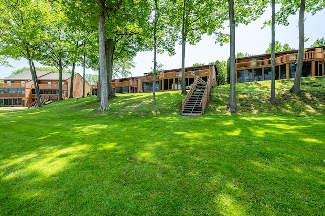 5576 N Watervliet Rd Unit 11, Watervliet, MI 49098 - view of green lawn featuring stairway and a wooden deck