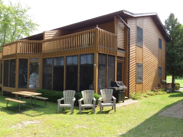 5576 N Watervliet Rd Unit 11, Watervliet, MI 49098 - rear view of house featuring a balcony, a yard, and a sunroom