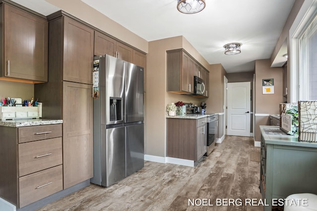 16507 Sleeper St, Grand Haven, MI 49417 - kitchen featuring stainless steel appliances, light wood-style flooring, and baseboards