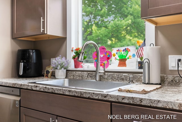 16507 Sleeper St, Grand Haven, MI 49417 - kitchen featuring stainless steel dishwasher, a sink, light countertops, and dark brown cabinetry