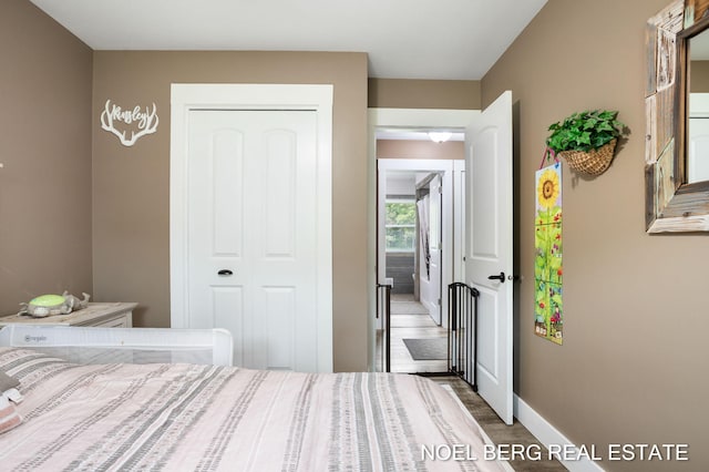 16507 Sleeper St, Grand Haven, MI 49417 - bedroom featuring baseboards, a closet, and wood finished floors