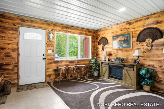 16507 Sleeper St, Grand Haven, MI 49417 - tiled foyer entrance with a glass covered fireplace and wooden walls