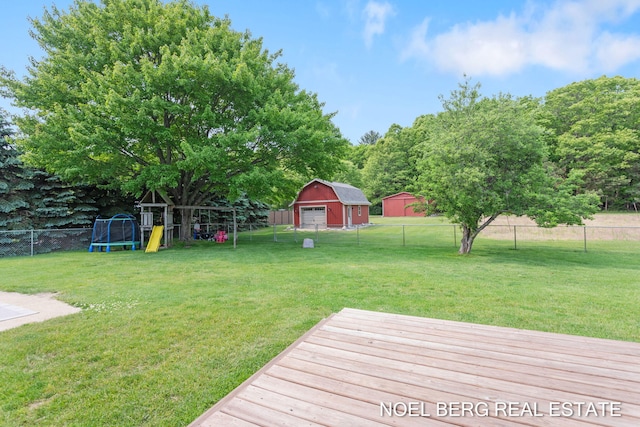 16507 Sleeper St, Grand Haven, MI 49417 - view of yard featuring a playground, a detached garage, a deck, and an outbuilding