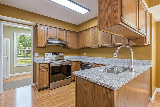 1196 Rathfon Cir, Saline, MI 48176 - kitchen with stainless steel appliances, under cabinet range hood, a sink, and light wood finished floors
