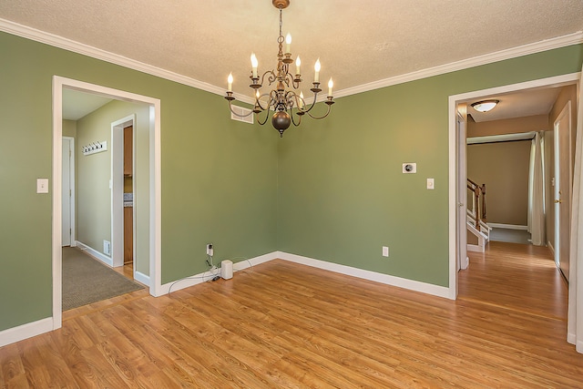1196 Rathfon Cir, Saline, MI 48176 - unfurnished room featuring light wood finished floors, a textured ceiling, a chandelier, baseboards, and crown molding